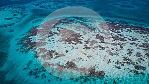 Aerial view of tropical island at Glover`s Reef Atoll in Belize with kayaks