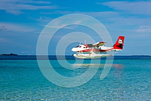 Aerial view of a tropical island in the Indian ocean with seaplane approaching, Maldives