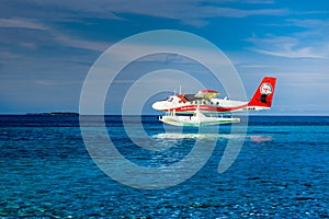 Aerial view of a tropical island in the Indian ocean with seaplane approaching, Maldives