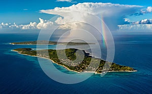 Aerial view of a tropical island after storm rainbow