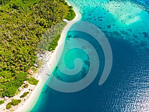 Aerial view tropical paradise pristine beach rainforest blue lagoon bay coral reef caribbean sea turquoise water at Banyak Islands