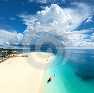 Aerial view of tropical sea coast, empty sandy beach and boat