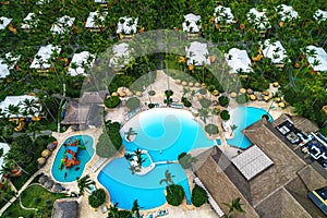 Aerial view of tropical swimming pool and palm trees in luxury resort