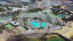 Aerial view of tropical swimming pool and palm trees in luxury resort