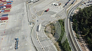 Aerial view of a truck entering the port to load cargo from a container ship.