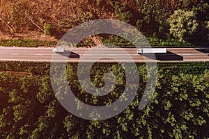 Aerial view of truck on road through forest landscape