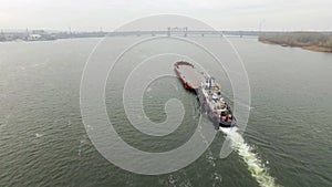 Aerial view of tug boat pushing empty barge