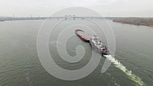 Aerial view of tug boat pushing empty barge