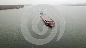 Aerial view of tug boat pushing empty barge