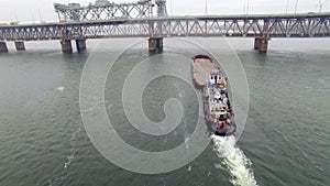 Aerial view of tug boat pushing empty barge