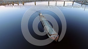 Aerial view of tug boat pushing empty barge.