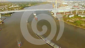 Aerial view of tug boat or ship, container transportation ship on chao phraya river, transportation concept, tilt-up camera shot,