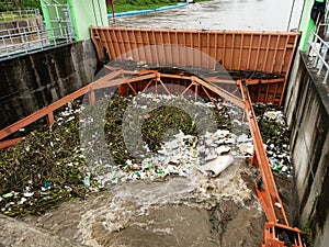 Aerial view of turbid brown forest water released by concrete dam drainage channels as water overflows in the rainy season with