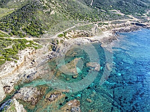 Aerial view of the turquoise sea by the rocky shore in La Frana coastline