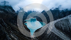 Aerial view on turquoise water lake Paron surrounded by mountains in Huaraz