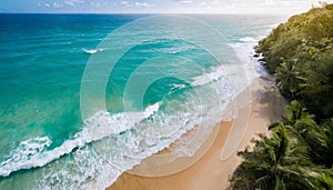 Aerial view of turquoise waves crashing on sunny sandy beach