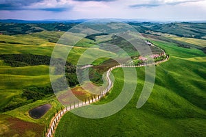 Aerial view of Tuscany rural landscape, road on rolling landscape at sunset, Agriturismo Baccoleno, Asciano, Italy