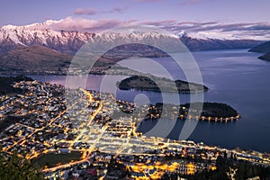 Aerial night view of twilight Queenstown and snow covered Remarkables, New Zealand