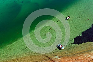 Aerial view of two fishing boats mooring on turquoise water