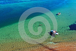 Aerial view of two fishing boats mooring on turquoise water