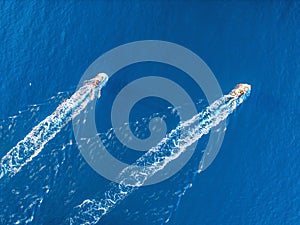 Aerial view of two fishing boats in the sea at sunset in summer