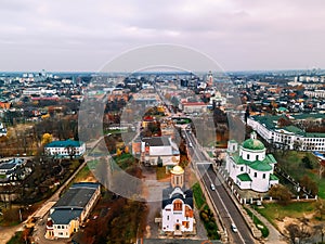 Aerial view of two old churches near river and bridge in small european city