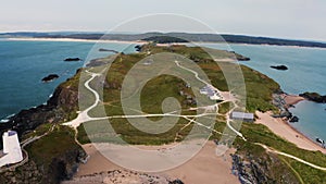 Aerial view of Twr Mawr lighthouse meaning great tower in Welsh on Ynys Llanddwyn on Anglesey Wales marks the western