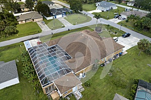 Aerial view of typical contemporary american private house with outside lanai enclosure covering big swimming pool