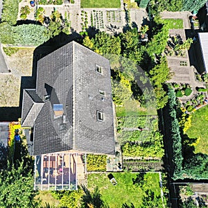 Aerial view of a typical German single-family house on a plot of land used for gardening with a drone