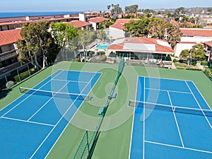 Aerial view of typical south california community condo with tennis court and pool