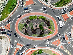 Aerial view of typical urban traffic circle with vehicles