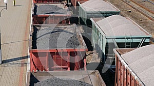 Aerial view UHD of freight train with wagons and standing train with coal