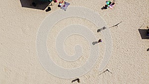 Aerial view umbrellas and summertime beach activities on sandy shorelines at City Beach Park in Granbury, Texas