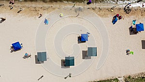 Aerial view umbrellas and summertime beach activities on sandy shorelines at City Beach Park in Granbury, Texas