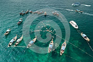 Aerial view of unidentified tourists snorkeling activity at Jabang pinnacle, Lipe Island, Thailand.