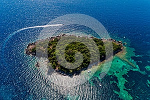 Aerial view of uninhabited island near of Agia Paraskeui Beach with turquoise sea in Parga area, Ionian sea, Epirus, Greece