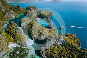 Aerial view of a unique blue lagoon surrounded by jagged limestone cliffs located on tropical Miniloc Island, El Nido photo