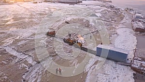 Aerial view of the unloading barge process. Clip. Transporting large container from the cargo ship with a tractor.