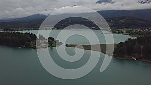 Aerial view on the upper ends of Ossiacher Lake in Carinthia, Austria on a summer day with great cloudscape