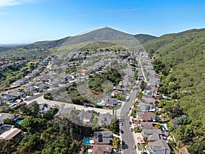 Aerial view of upper middle class neighborhood with residential house and swimming pool in valley
