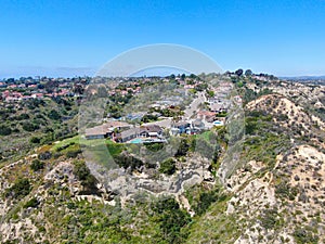 Aerial view of upper middle class neighborhood with residential house and swimming pool in a valley