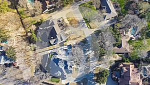 Aerial view upscale two story house with circular driveway, swimming pool, large backyard, suburban low density housing small