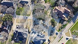 Aerial view upscale two story house with circular driveway, swimming pool, large backyard, suburban low density housing small