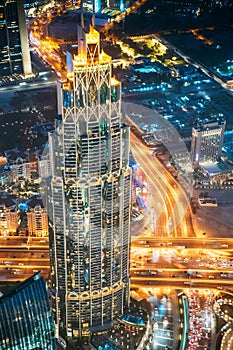 Aerial View Of Urban Background Of Illuminated Cityscape With Tower And Skyscraper In Dubai. Street Night Traffic In