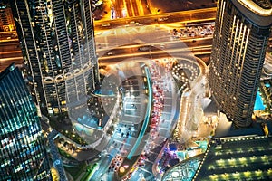 Aerial View Of Urban Background Of Illuminated Cityscape With Towers In Dubai. Street Night Traffic In Dudai Skyline