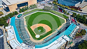 Aerial View of Urban Baseball Stadium with Vibrant Field and Cityscape