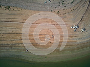 Aerial view of the ValdecaÃ±as reservoir, with green water from the algae and natural lines of the descent of the water. Natural