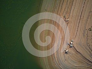 Aerial view of the ValdecaÃ±as reservoir, with green water from the algae and natural lines of the descent of the water. Natural