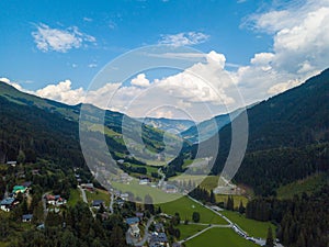 Aerial view from the valley head of the Hinterglemm Mountains to Hinterglemm and Saalbach on a summer day in the Alps at