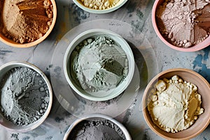 aerial view of various colored clay powders in bowls